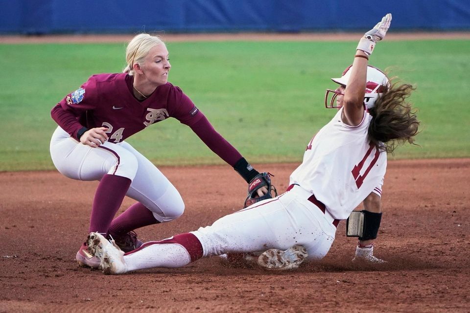 Florida State third baseman Sydney Sherrill, left, tags