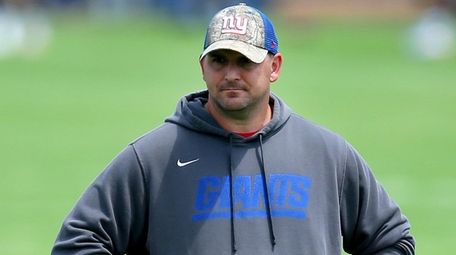 Giants head coach Joe Judge watches practice during