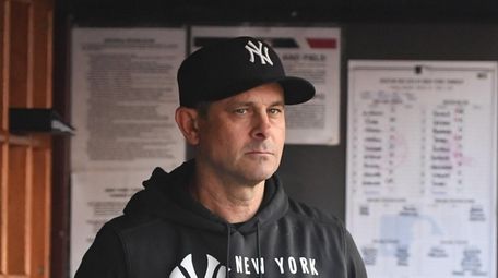 Yankees manager Aaron Boone looks on from the