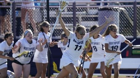 Northport's Kaylie Mackiewicz (11) leads her team onto