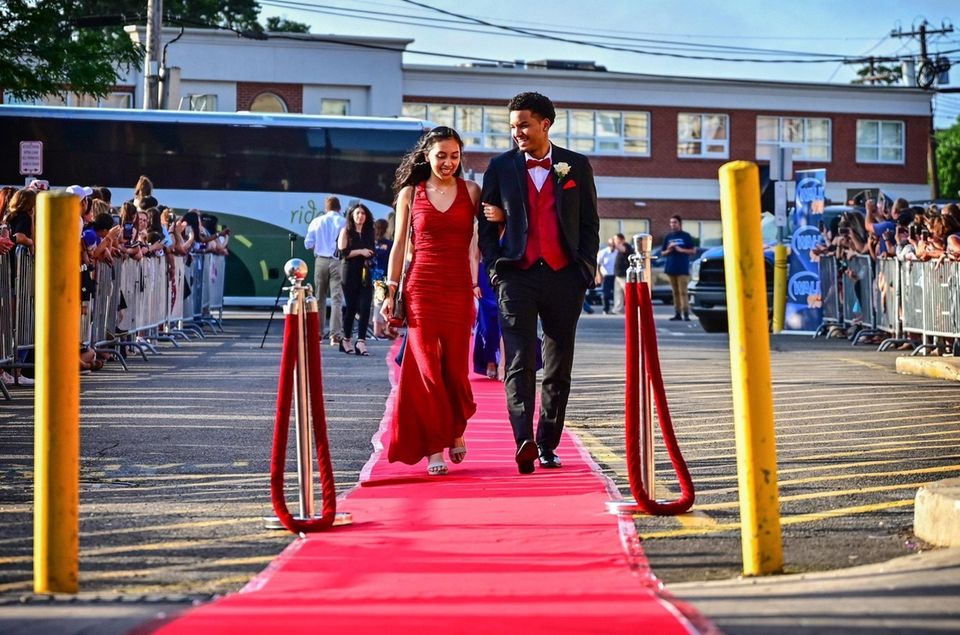 Celena Coutard and Kenny Daniels walk the red