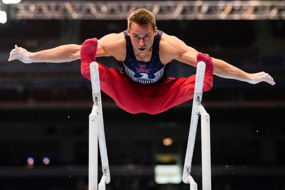 Sam Mikulak competes on the parallel bars during
