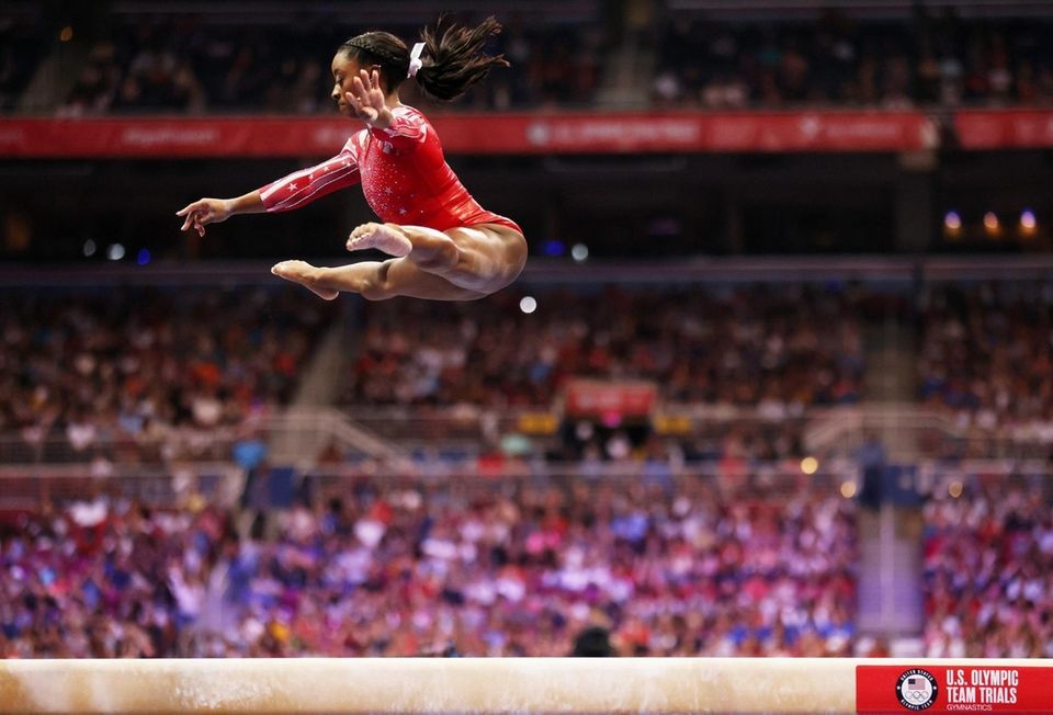 Simone Biles competes on the balance beam during