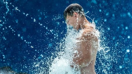Jacob Gaertner, 11, cools off at Geiger Park