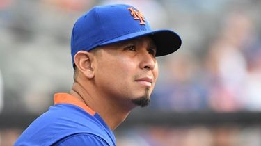 Mets pitcher Carlos Carrasco looks on from the