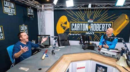 Evan Roberts, left, and Craig Carton sit in