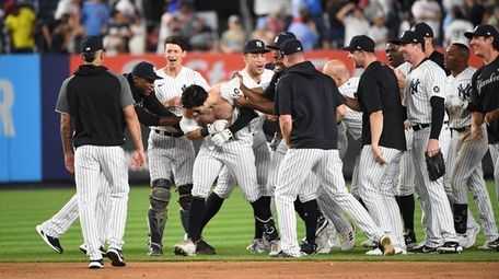 The Yankees' Ryan LaMarre is mobbed by teammates