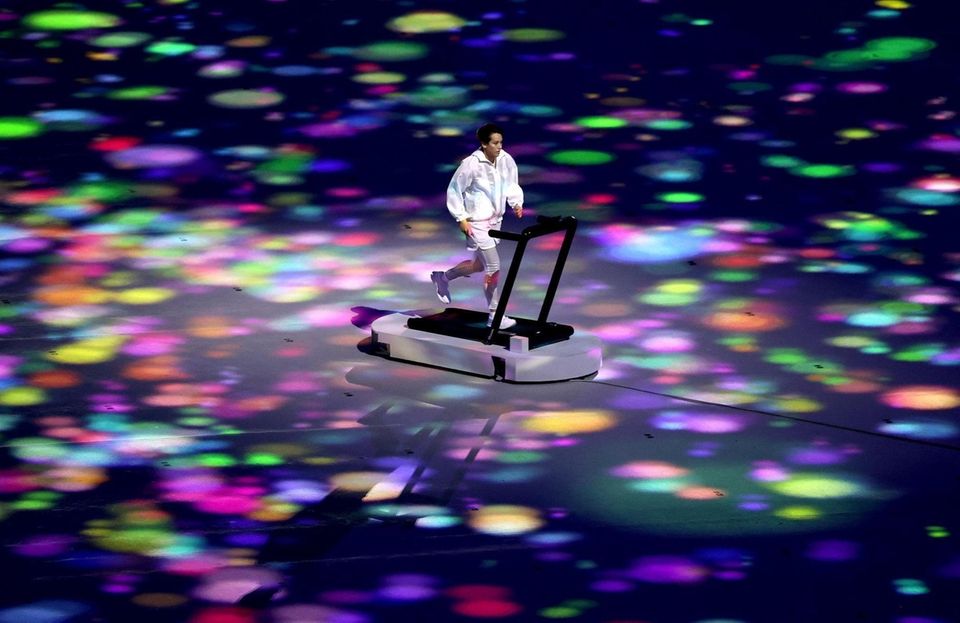 A performer runs on a treadmill during the