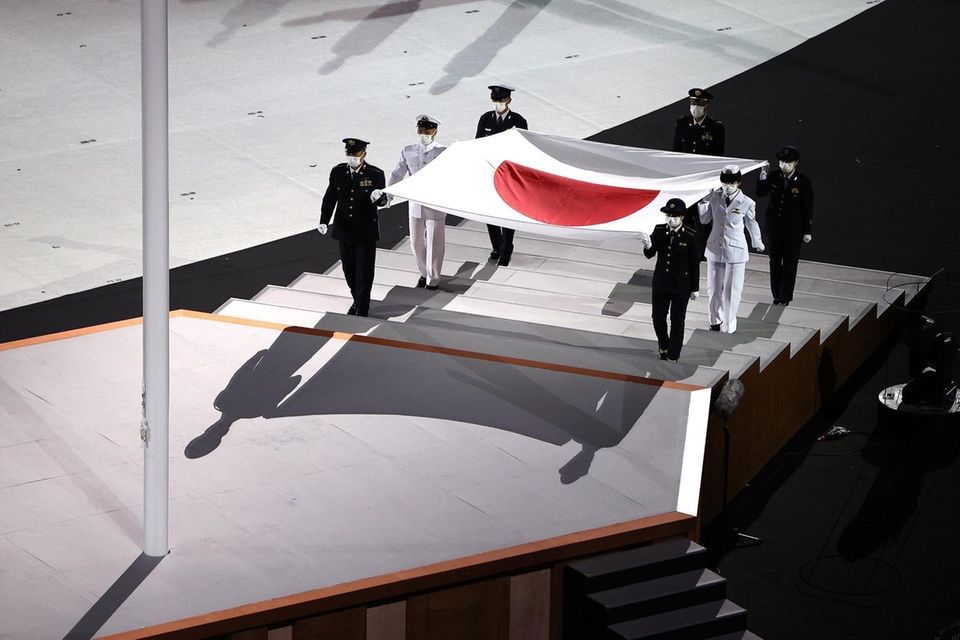The Japanese flag is carried onto the stage