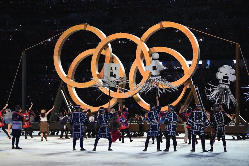 Perfomers are seen dancing infront of the Olympic