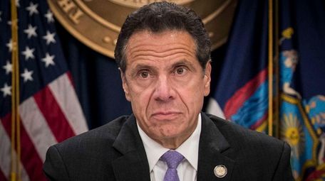 Gov. Andrew Cuomo listens during a news conference