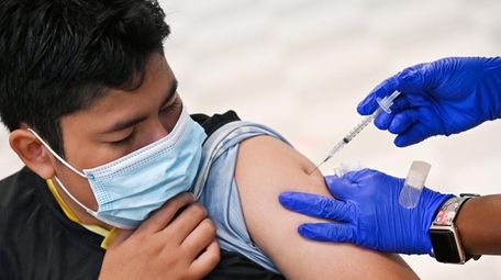 Diego Mendez, 12, of Freeport, gets a COVID-19
