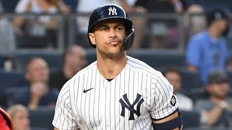 Yankees designated hitter Giancarlo Stanton reacts after he