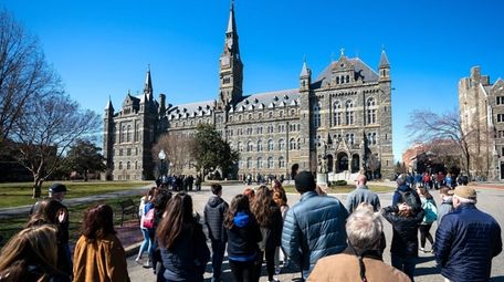 Prospective students and their parents approach tour Georgetown