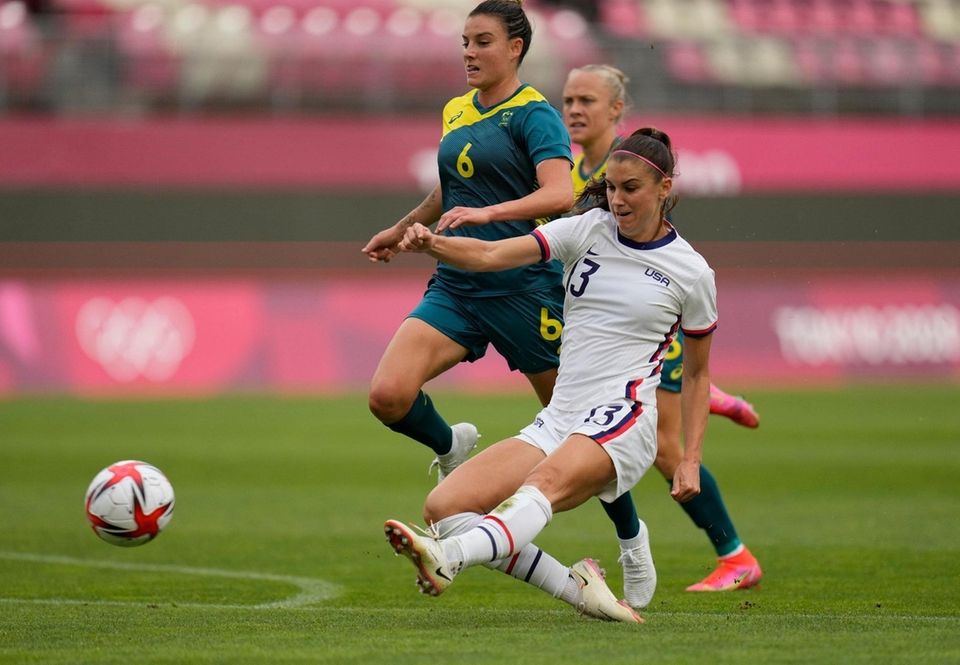 United States' Alex Morgan, right, kicks the ball