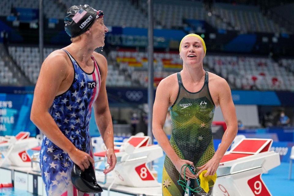 Ariarne Titmus of Australia, right, leaves the pool