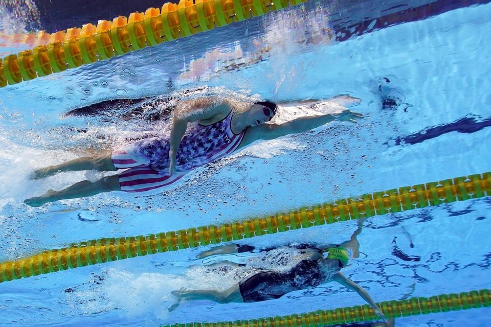 United State's Katy Ledecky, top, swims in a