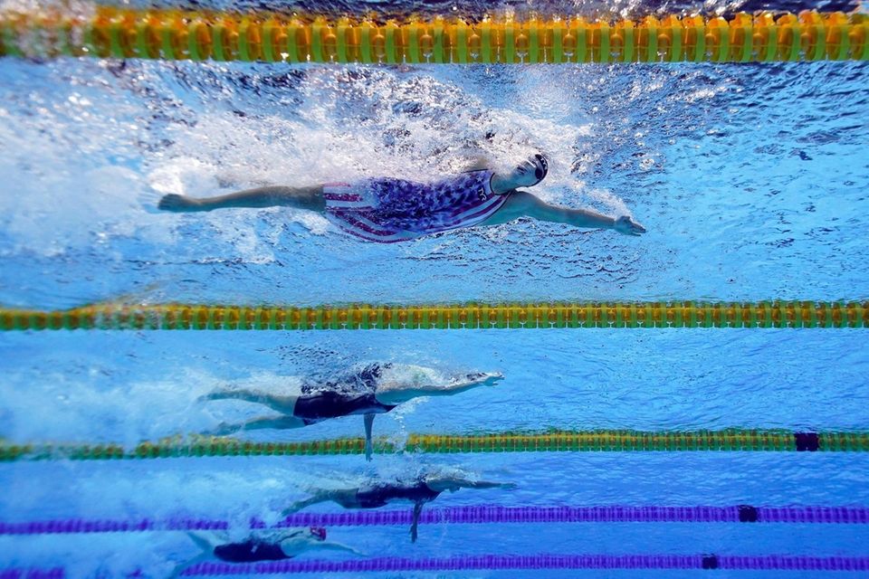 United State's Katy Ledecky, top, swims in a