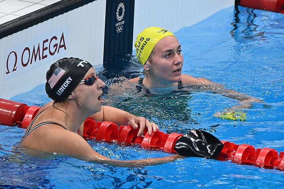 Australia's Ariarne Titmus (R) reacts next to USA's