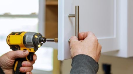 Replacing dated kitchen cabinet knobs is an easy