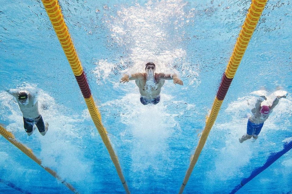Caeleb Dressel of Team United States, center, competes