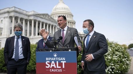 Rep. Tom Suozzi (D-Glen Cove), center, seen speaking
