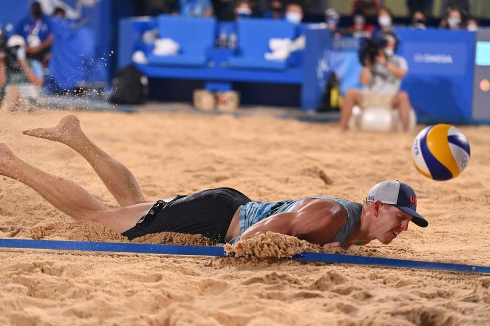 USA's Tri Bourne dives in the sand while