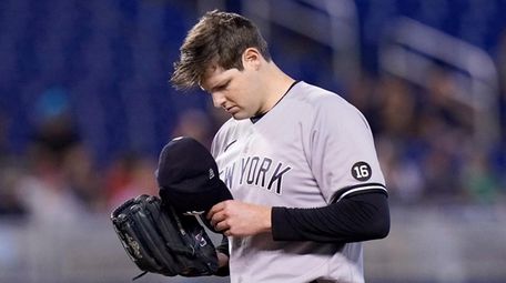 Yankees starting pitcher Jordan Montgomery removes his cap