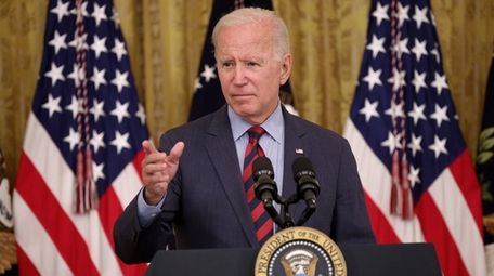 President Joe Biden takes questions at the White