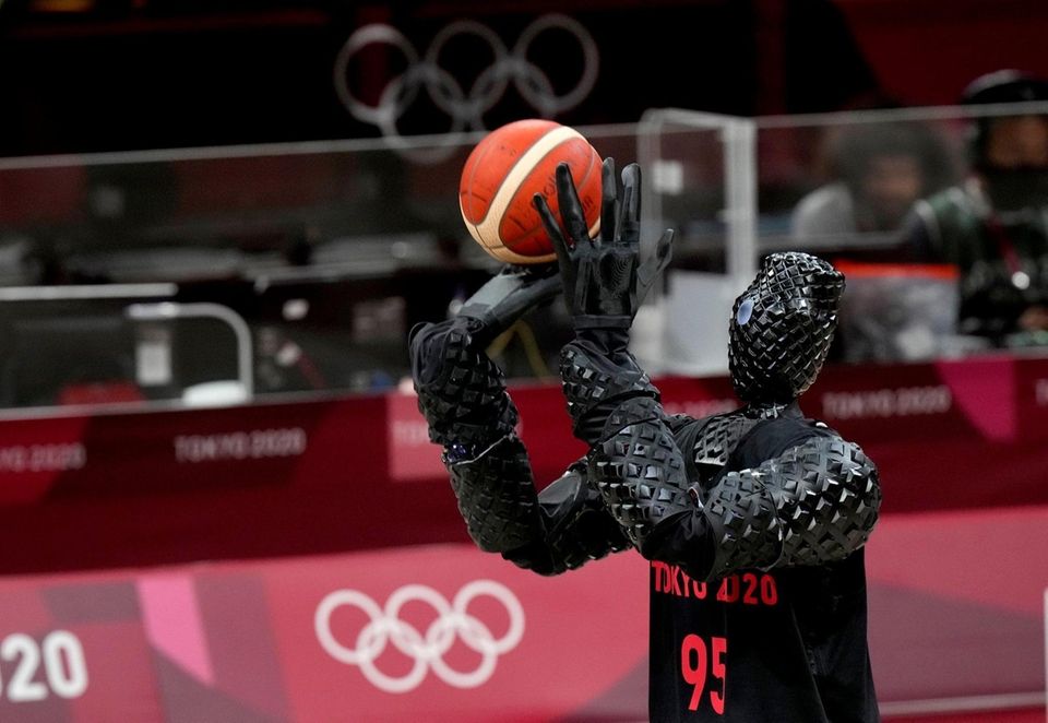 A robot holds the ball during women's basketball