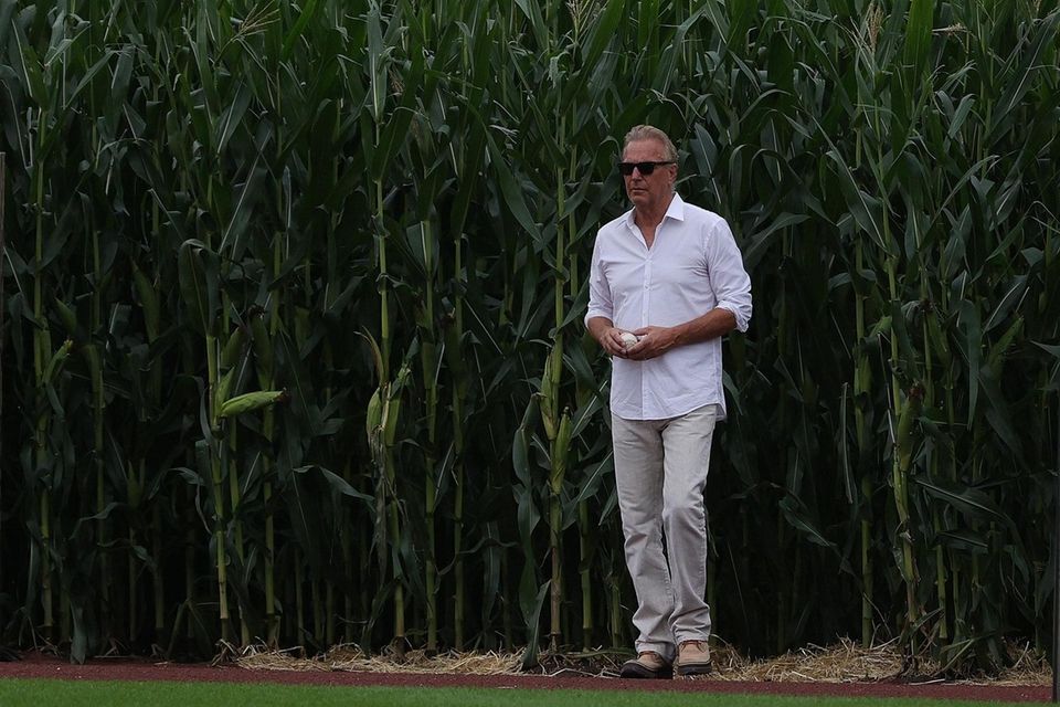 Actor Kevin Costner walks onto the field prior