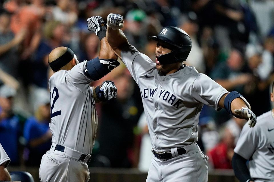New York Yankees' Giancarlo Stanton celebrates with Rougned