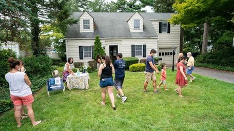 Prospective buyers wait for a tour of a