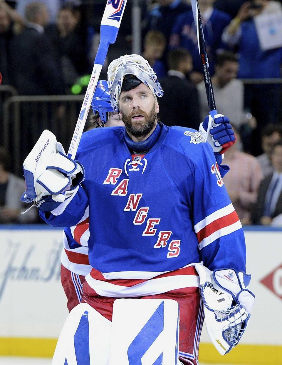 New York Rangers goalie Henrik Lundqvist raises his