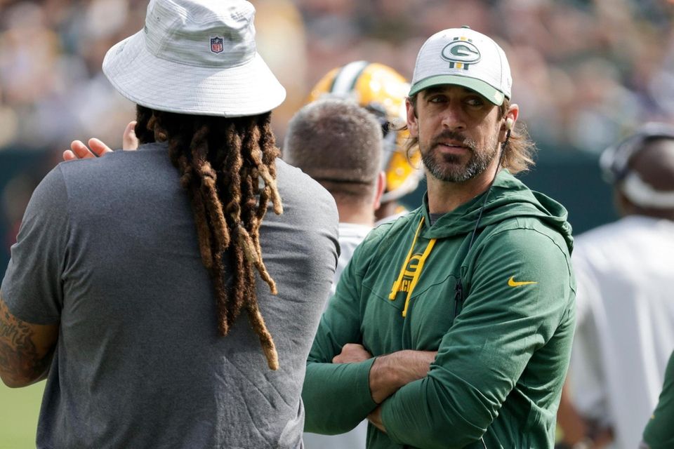Green Bay Packers' Aaron Rodgers watches from the