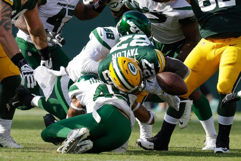 Green Bay Packers' Patrick Taylor fumbles as he