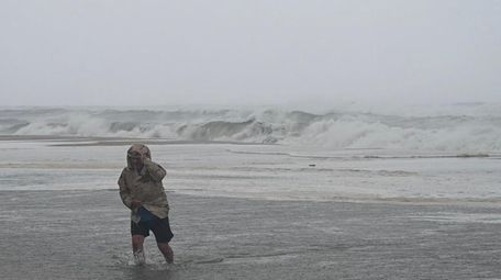 A man walks through the surf at Coopers