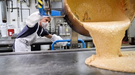 An employee pours English toffee inside the Nassau