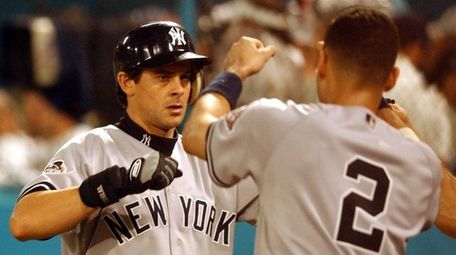 Yankees third baseman Aaron Boone is greeted by