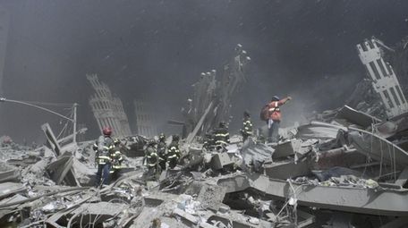 Emergency personnel look for victims and fight fires