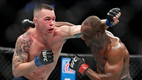 Kamaru Usman, right, fights Colby Covington in a