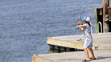 Odin Farid fishes off the dock at the