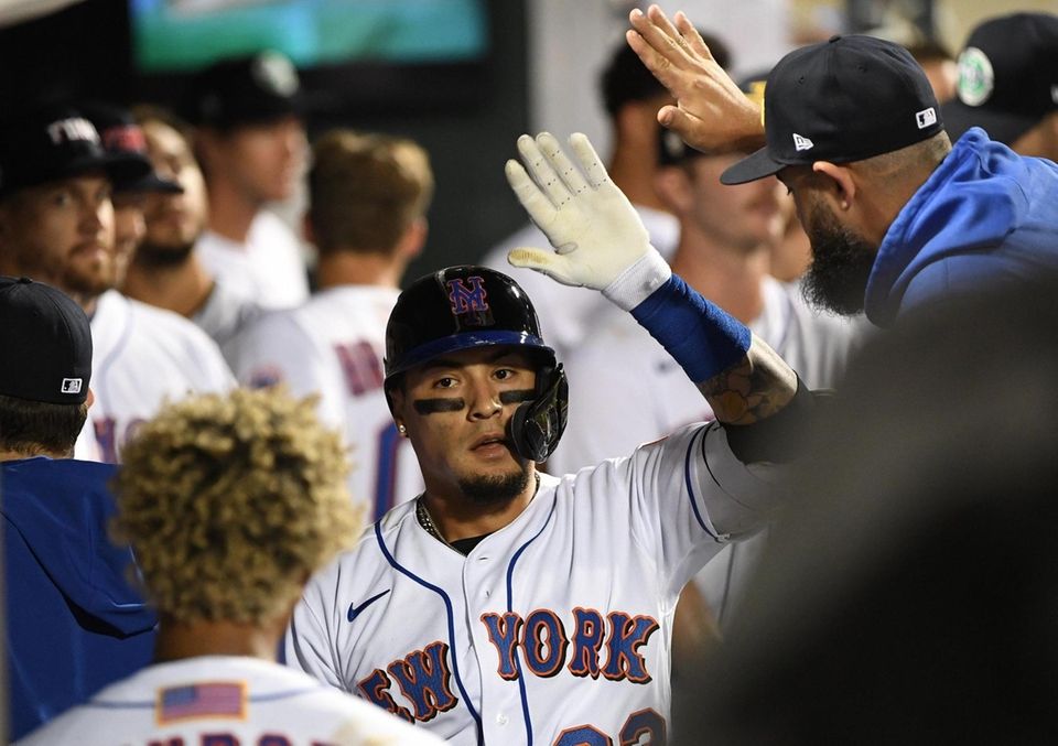 New York Mets' Javier Baez is greeted in