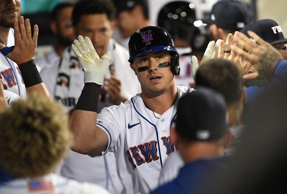 New York Mets catcher James McCann is greeted