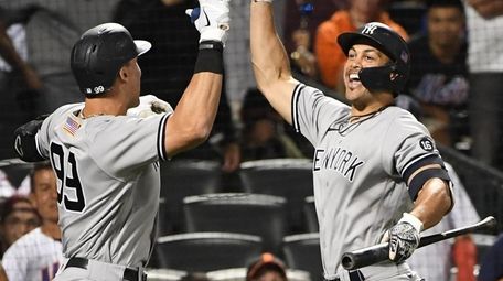 The Yankees' Aaron Judge is greeted by Giancarlo