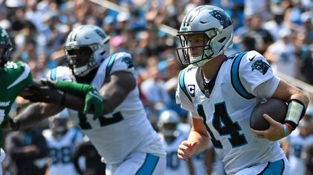 Sam Darnold #14 of the Carolina Panthers runs