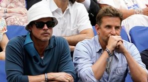 Brad Pitt, left, and Bradley Cooper watch play