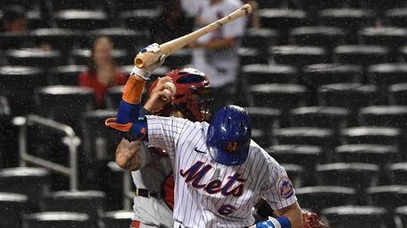 Mets left fielder Jeff McNeil reacts after he