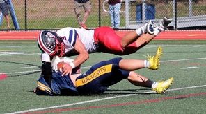 Shoreham-Wading River's Max Barone (bottom) intercepts the Miller