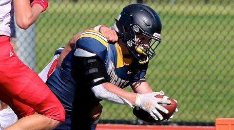 Shoreham-Wading River RB Max Barone fights off the